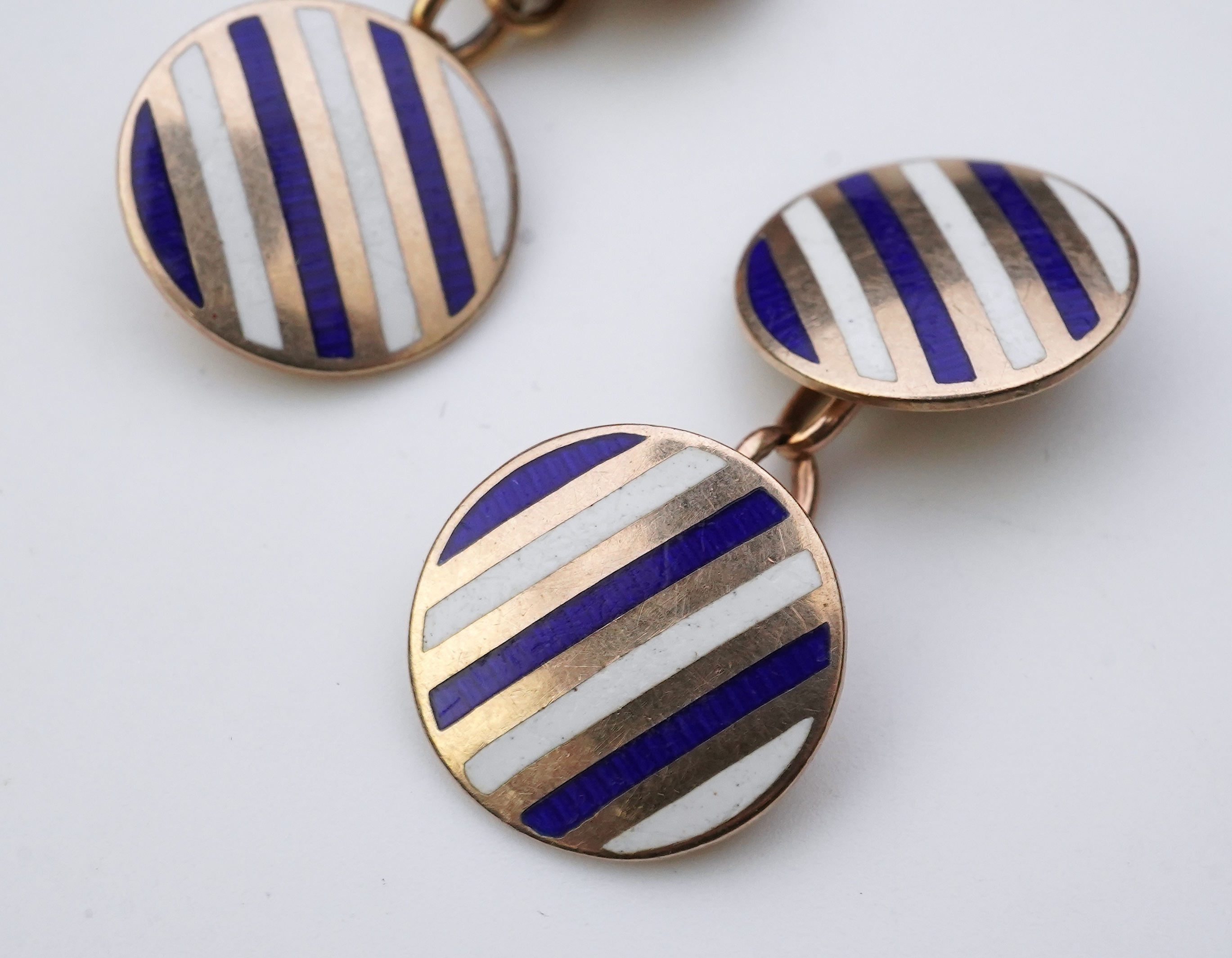 A pair of gold and enamel cufflinks